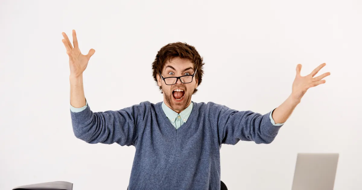 両手を上げ叫んでいる男性。webライターとしてミスを犯してしまい、叫び声をあげパニックになっている