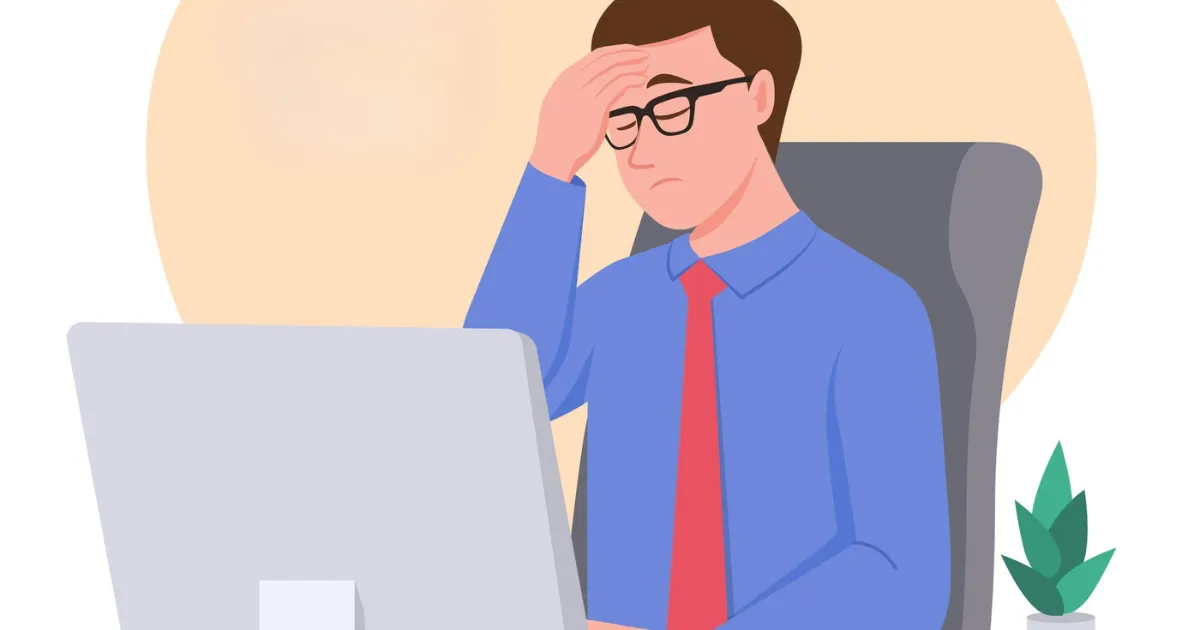 パソコンの前で頭を抱える、会社員の男性のイラスト。「経費」に含めていいものなのか、迷っている様子を表している